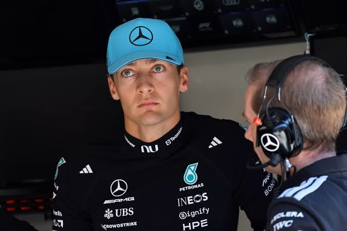 George Rusell is firesuit with blue mercedes cap